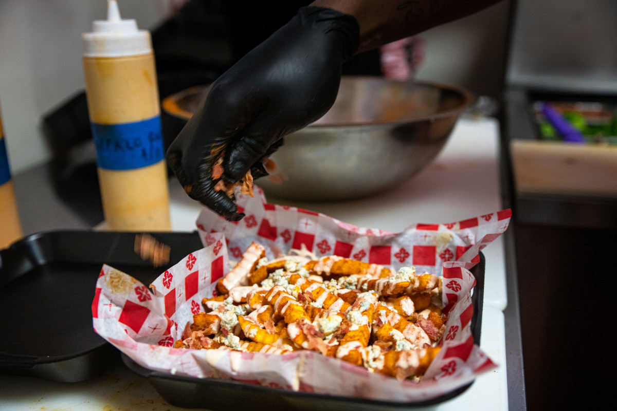 Fries with white dip and cheese on top