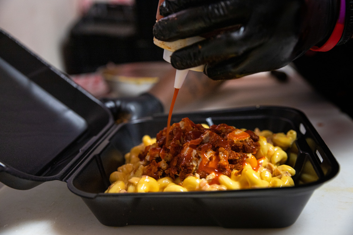 Pasta with meat, sauce and cheese, red dip on top